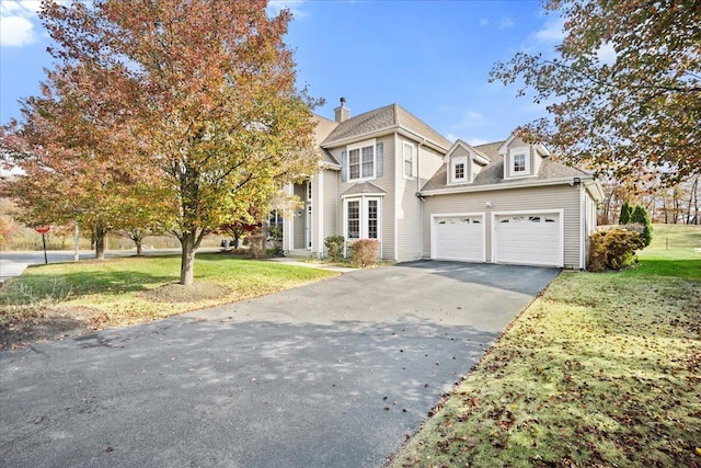 view of front of property with a front yard and a garage