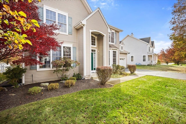 view of front facade featuring a front lawn and a garage