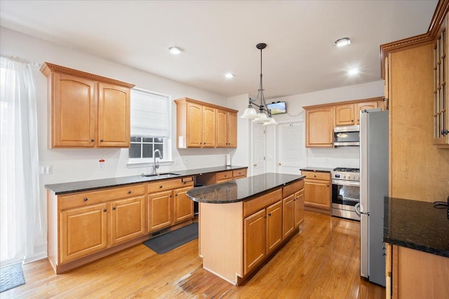 kitchen with light hardwood / wood-style flooring, a center island, stainless steel appliances, and sink