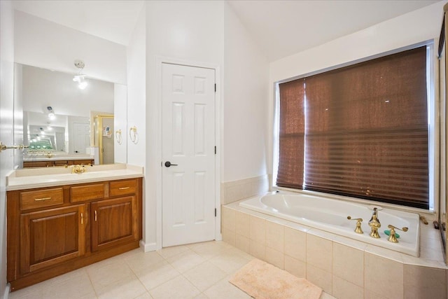 bathroom with vanity, tiled bath, tile patterned floors, and lofted ceiling