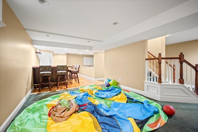 recreation room with carpet and indoor bar