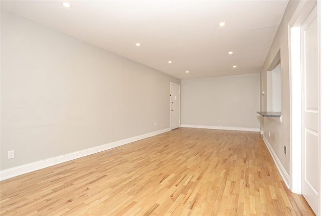 unfurnished room with light wood-type flooring