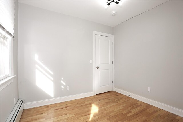 spare room featuring light hardwood / wood-style flooring and baseboard heating