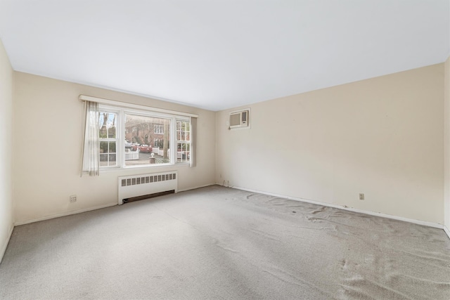 empty room with a wall mounted air conditioner, light colored carpet, and radiator