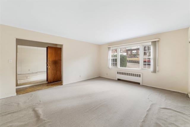 unfurnished room with carpet floors and radiator