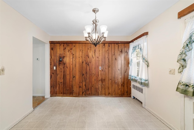 interior space featuring radiator heating unit and an inviting chandelier