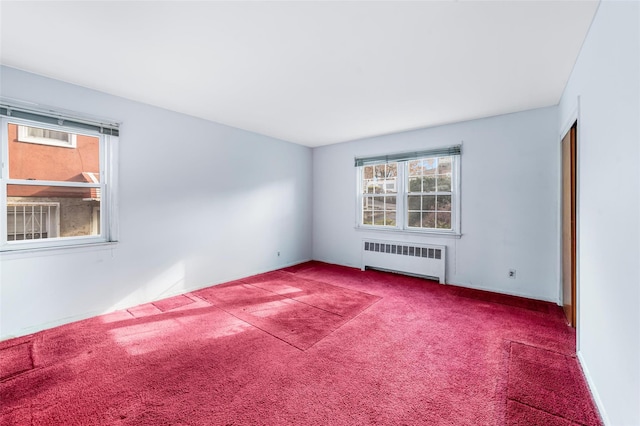 empty room featuring carpet and radiator