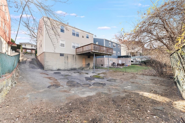 back of house featuring a deck