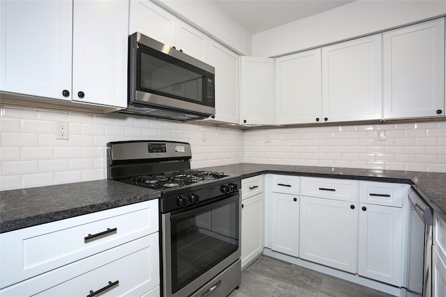 kitchen with decorative backsplash, white cabinets, and appliances with stainless steel finishes