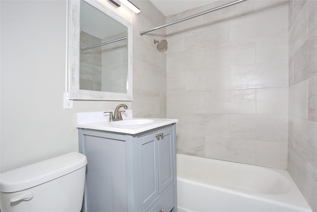 full bathroom with vanity, toilet, and tiled shower / bath