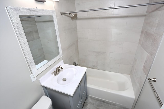 full bathroom featuring toilet, vanity, and tiled shower / bath combo