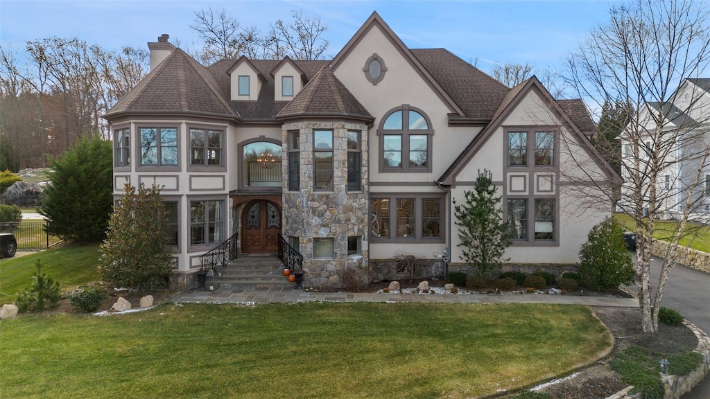 view of front of house featuring a front yard and french doors