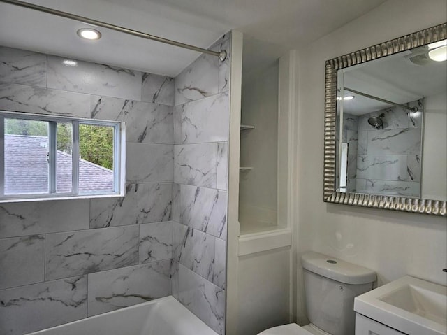 full bathroom featuring vanity, tiled shower / bath combo, and toilet