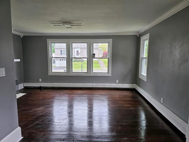 spare room with crown molding and dark wood-type flooring