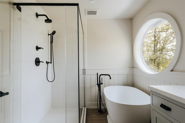 bathroom featuring shower with separate bathtub, vanity, and hardwood / wood-style flooring