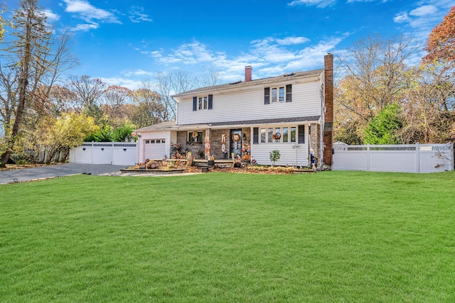 front facade featuring a garage and a front lawn