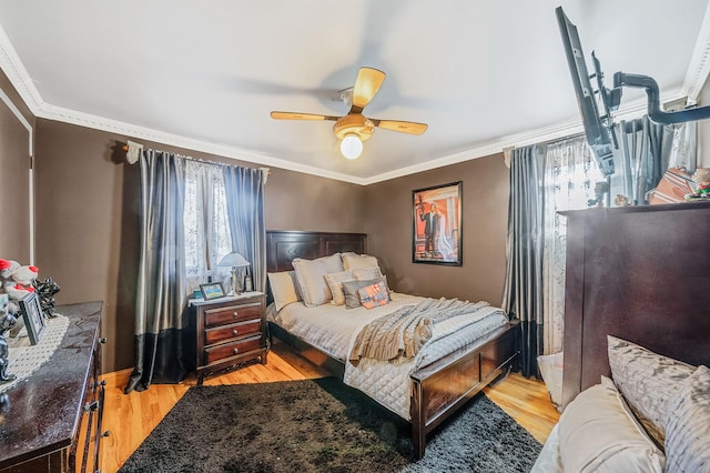 bedroom with ceiling fan, light hardwood / wood-style floors, and ornamental molding