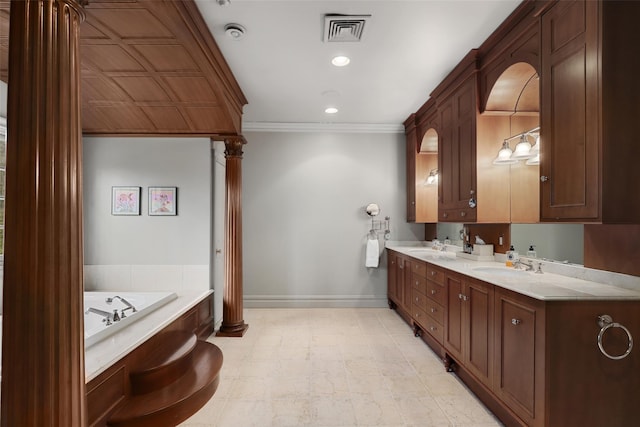 bathroom with ornamental molding, vanity, and a bathing tub