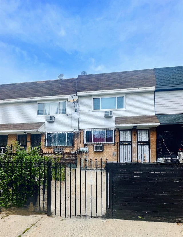 view of front of house featuring cooling unit and a wall mounted AC