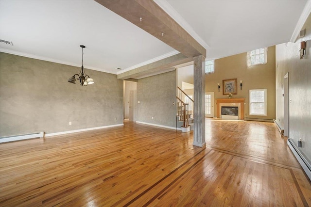 unfurnished living room with a towering ceiling, ornamental molding, a baseboard radiator, light hardwood / wood-style flooring, and beamed ceiling