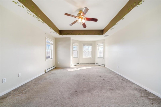 carpeted empty room featuring a tray ceiling, ceiling fan, and a baseboard heating unit