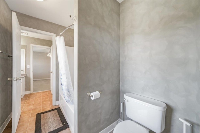 bathroom with tile patterned floors, shower / tub combo with curtain, and toilet