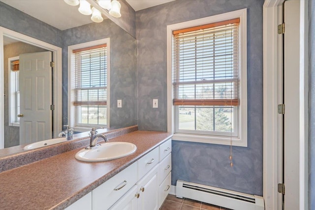 bathroom featuring tile patterned floors, vanity, a healthy amount of sunlight, and a baseboard heating unit