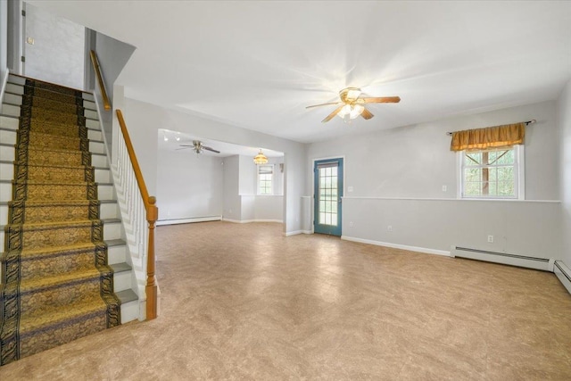 interior space with ceiling fan, a healthy amount of sunlight, and a baseboard heating unit