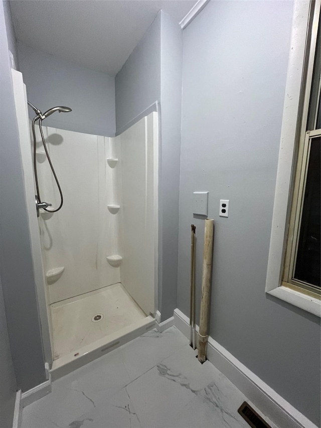 bathroom featuring walk in shower