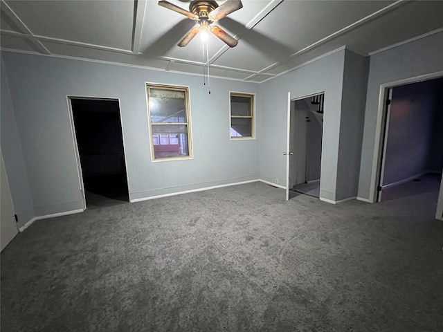 unfurnished bedroom with dark carpet and ceiling fan