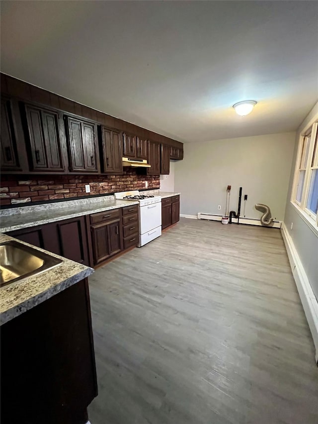 kitchen featuring baseboard heating, tasteful backsplash, dark brown cabinets, light hardwood / wood-style floors, and white range with gas stovetop