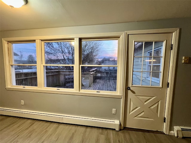 entryway with hardwood / wood-style flooring and baseboard heating