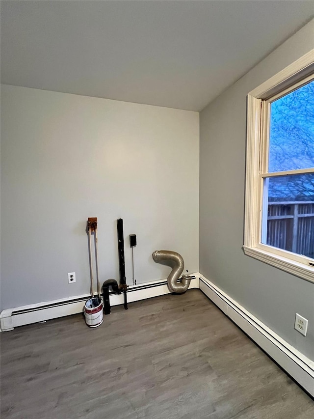 washroom with baseboard heating and hardwood / wood-style floors