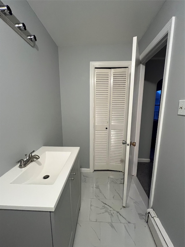 bathroom featuring vanity and baseboard heating