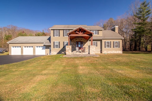 view of front of house with a garage and a front yard