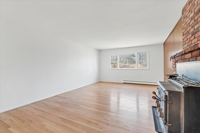 unfurnished living room with light hardwood / wood-style flooring and a baseboard radiator