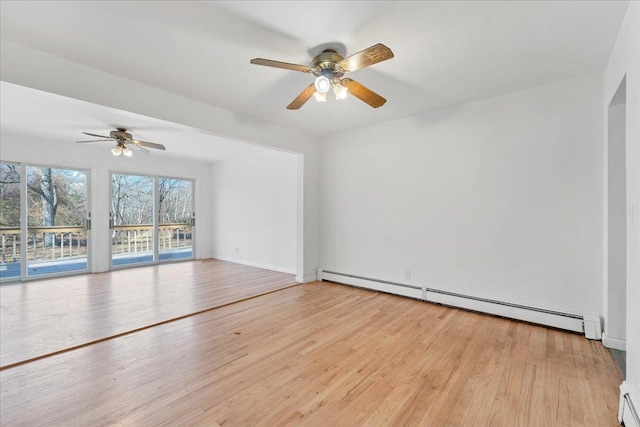 spare room featuring ceiling fan, a baseboard radiator, and light hardwood / wood-style floors