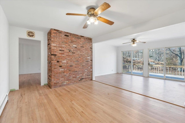 unfurnished living room with baseboard heating, light hardwood / wood-style flooring, ceiling fan, and brick wall