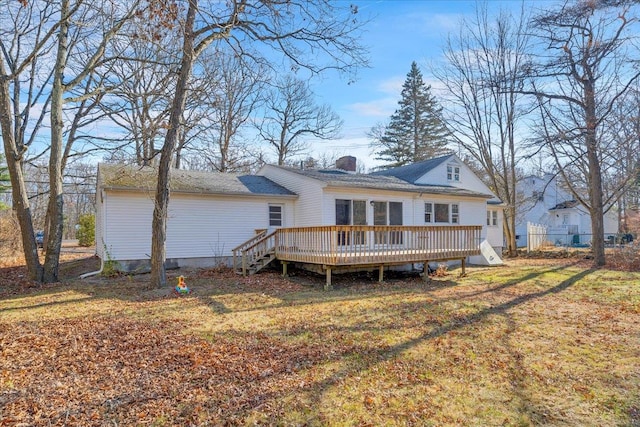 back of house with a lawn and a wooden deck