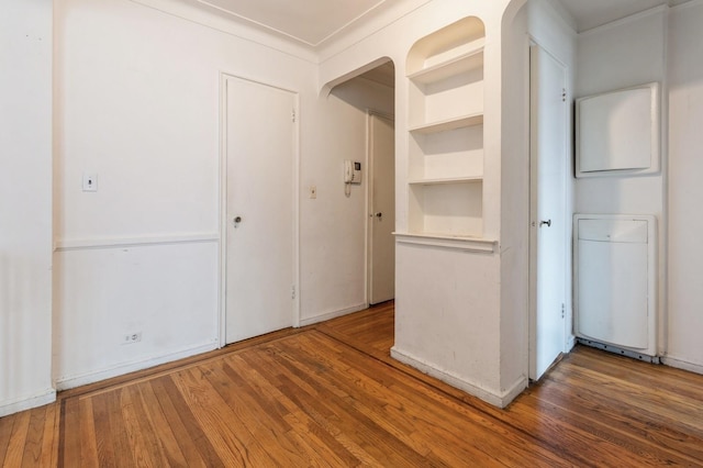 interior space with dark hardwood / wood-style flooring and crown molding