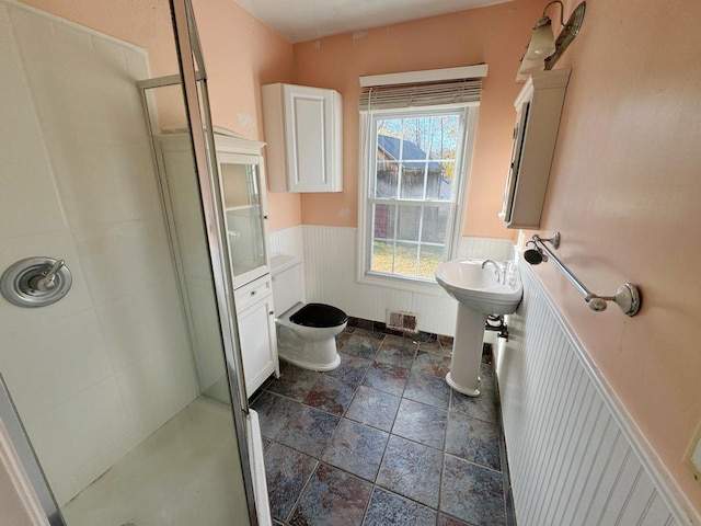 bathroom with toilet and walk in shower