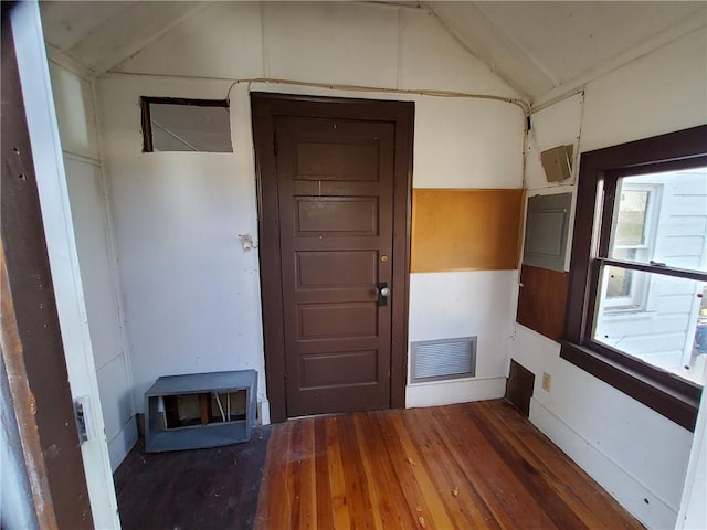 interior space featuring dark hardwood / wood-style flooring and lofted ceiling