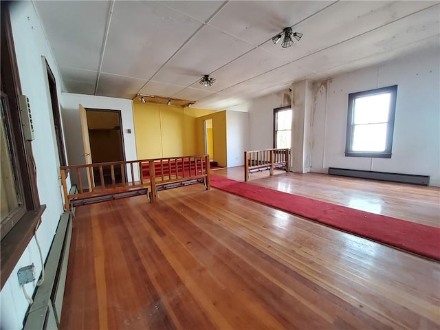 interior space featuring wood-type flooring and baseboard heating