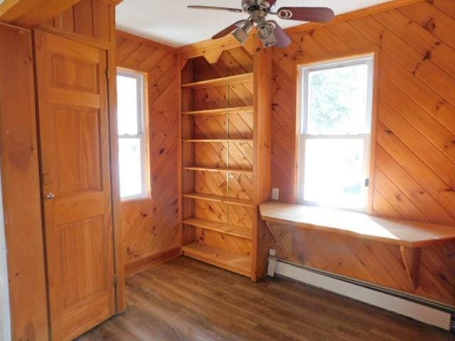 452 St Andrews Rd, Walden, NY 12586 - interior space with wood walls, a baseboard radiator, a ceiling fan, and wood finished floors