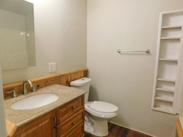 452 St Andrews Rd, Walden, NY 12586 - bathroom with wood finished floors, vanity, toilet, and built in features