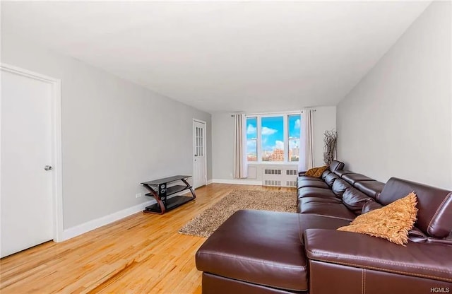 living room featuring hardwood / wood-style floors and radiator