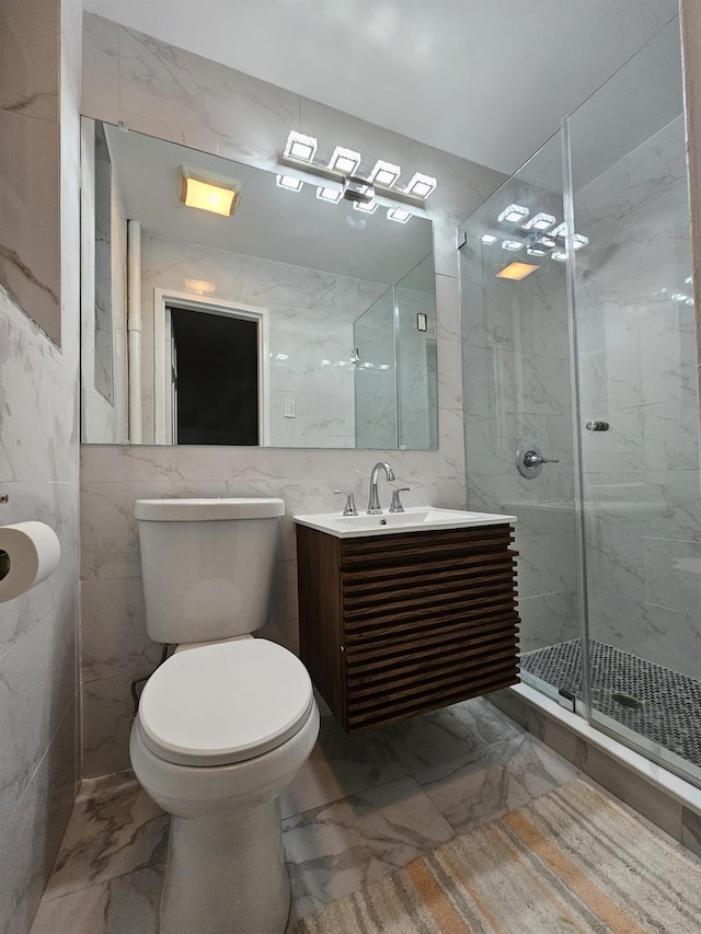 bathroom featuring vanity, toilet, tile walls, and a shower with shower door