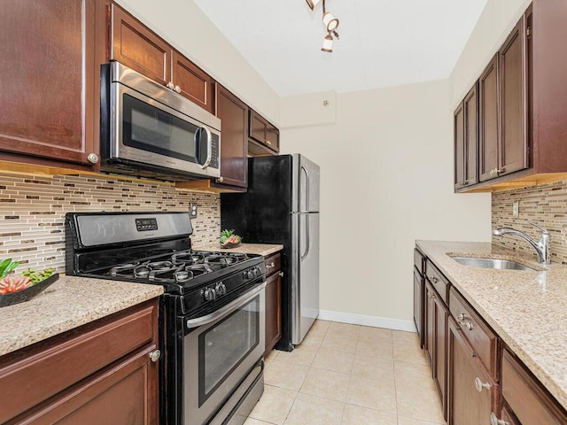 kitchen featuring decorative backsplash, light tile patterned flooring, sink, and appliances with stainless steel finishes