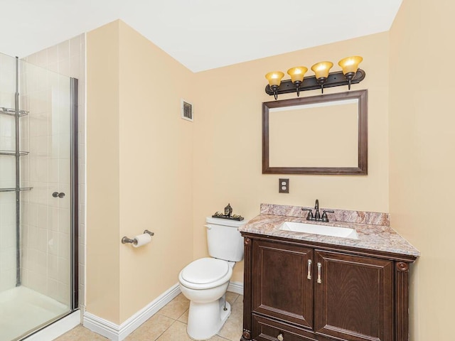 bathroom with toilet, vanity, tile patterned floors, and a shower with shower door