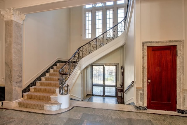 foyer with a high ceiling and a healthy amount of sunlight